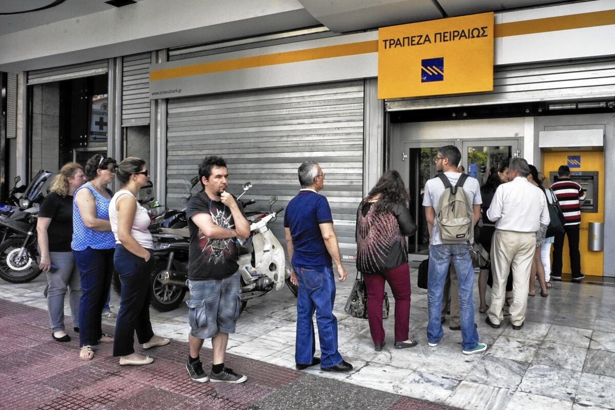 Investors hammered the Greek debt Monday, the first trading day after the call for a referendum. The yield, or interest rate, on its 10-year bond rose more than four full percentage points to 14.68%. Above, Greeks wait to withdraw cash Monday.