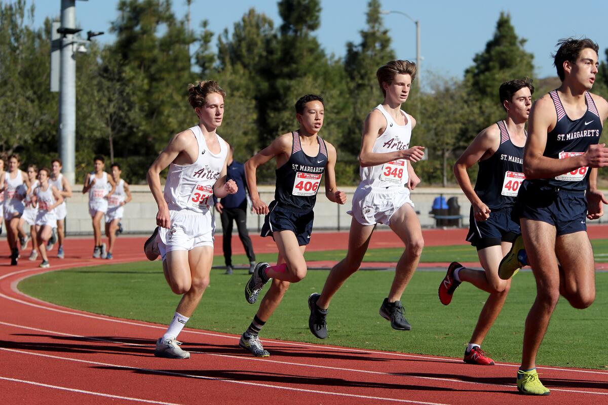 Laguna Beach's Christopher Drews (348) and William Goodwin (351) compete against St. Margaret's on Saturday.