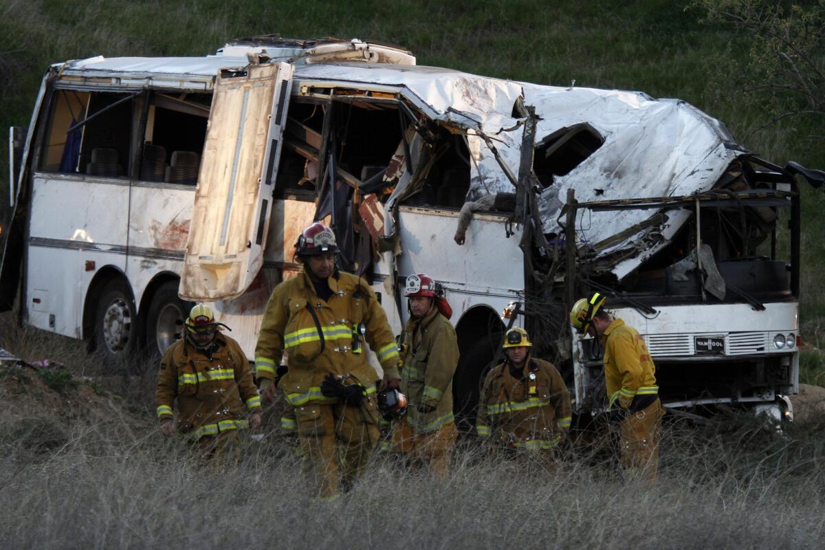 Investigators survey the scene of a tour bus crash in 2013 on Highway 38 near Yucaipa.