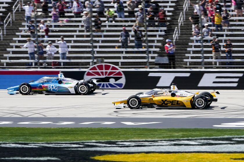 Josef Newgarden passes Scott McLaughlin at the finish line to win the NTT IndyCar Series.