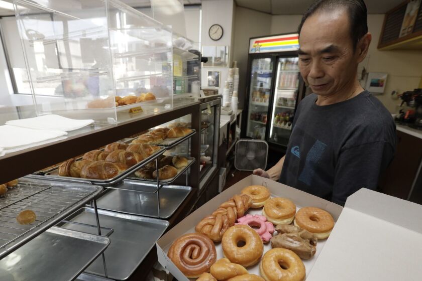 SEAL BEACH, CA NOVEMBER 20, 2018 --- Customers in Seal Beach are buying out all of John ChhanÕs his fresh-baked doughnuts so that he can leave to be with his wife, Stella, who is in a Costa Mesa nursing home after being diagnosed with a brain aneurysm. (Irfan Khan / Los Angeles Times)
