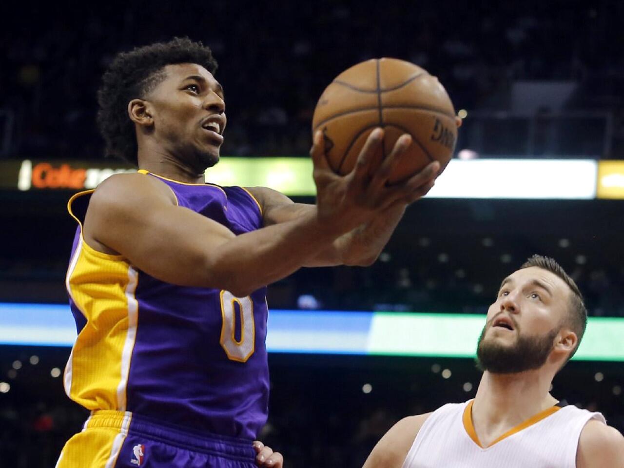The Lakers' Nick Young drives past center Miles Plumlee of the Phoenix Suns during a recent game.