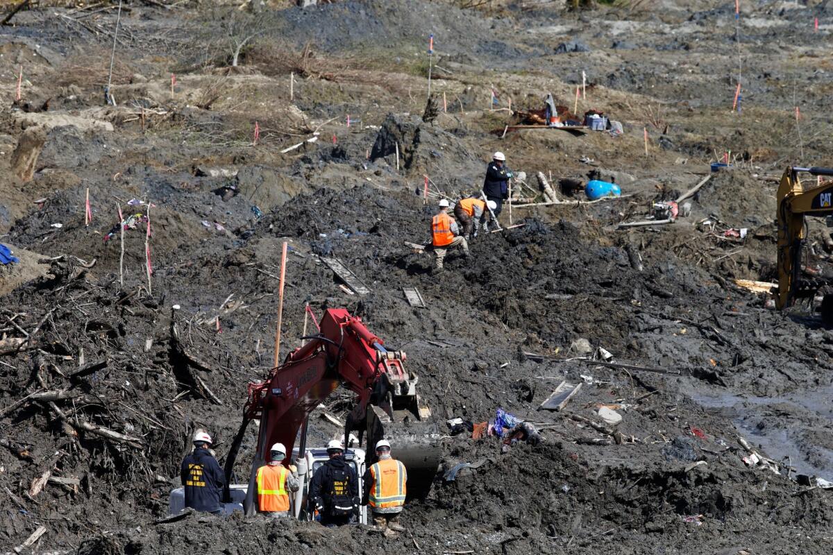 Search-and-rescue personnel continue the search for bodies buried in mud after the landslide in Oso, Wash. Thirty-nine bodies have been recovered from the scene.