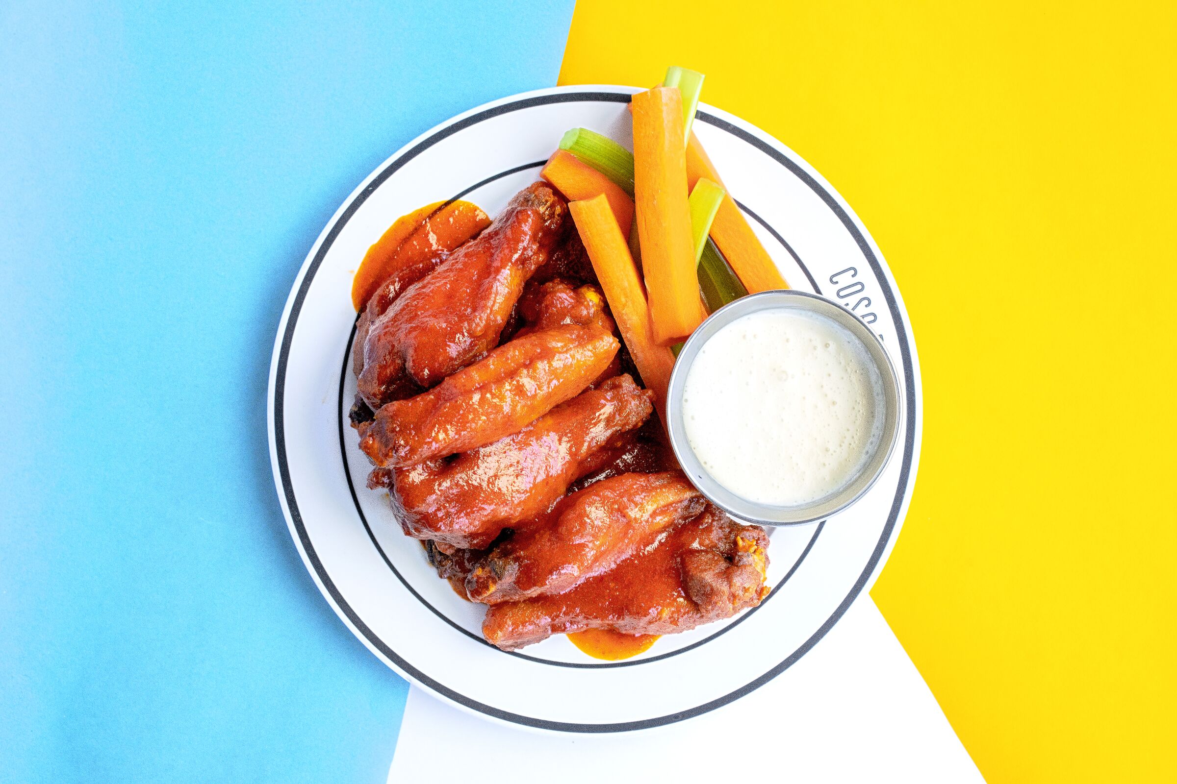 Chicken wings with Zach's Red Hot, carrots, celery and Gorgonzola dipping sauce at Cosa Buona in Los Angeles.