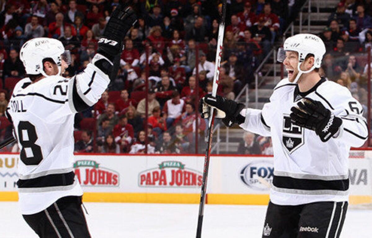 Jake Muzzin, right, celebrates with Jarret Stoll after scoring a third-period goal during the Kings¿ 4-2 victory over the Phoenix Coyotes at Jobing.com Arena earlier this season.