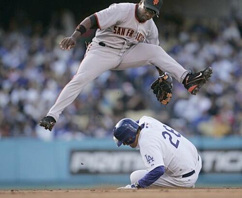 Dodgers base runner Jae Seo slides into a double play under the throw from Giants second baseman Ray Durham during the third inning.