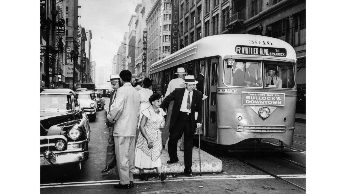July 25, 1955: Eastbound streetcar on 7th St. stops at Broadway to take on and discharge passengers as the city's lines return to normal service following end of strike.