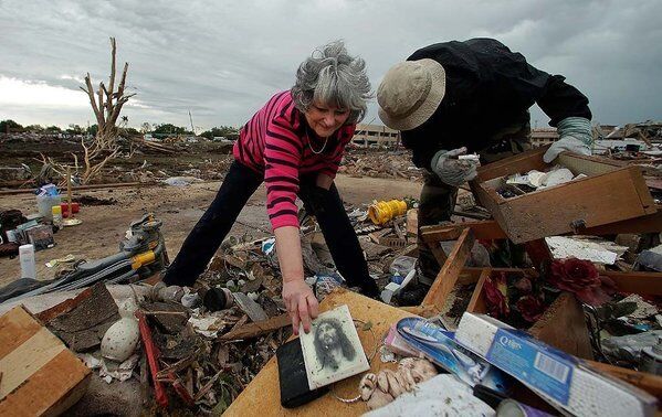 Lea Bessinger salvages belongings as she and her son Josh sort through the rubble of her tornado-ravaged home in Moore, Okla.