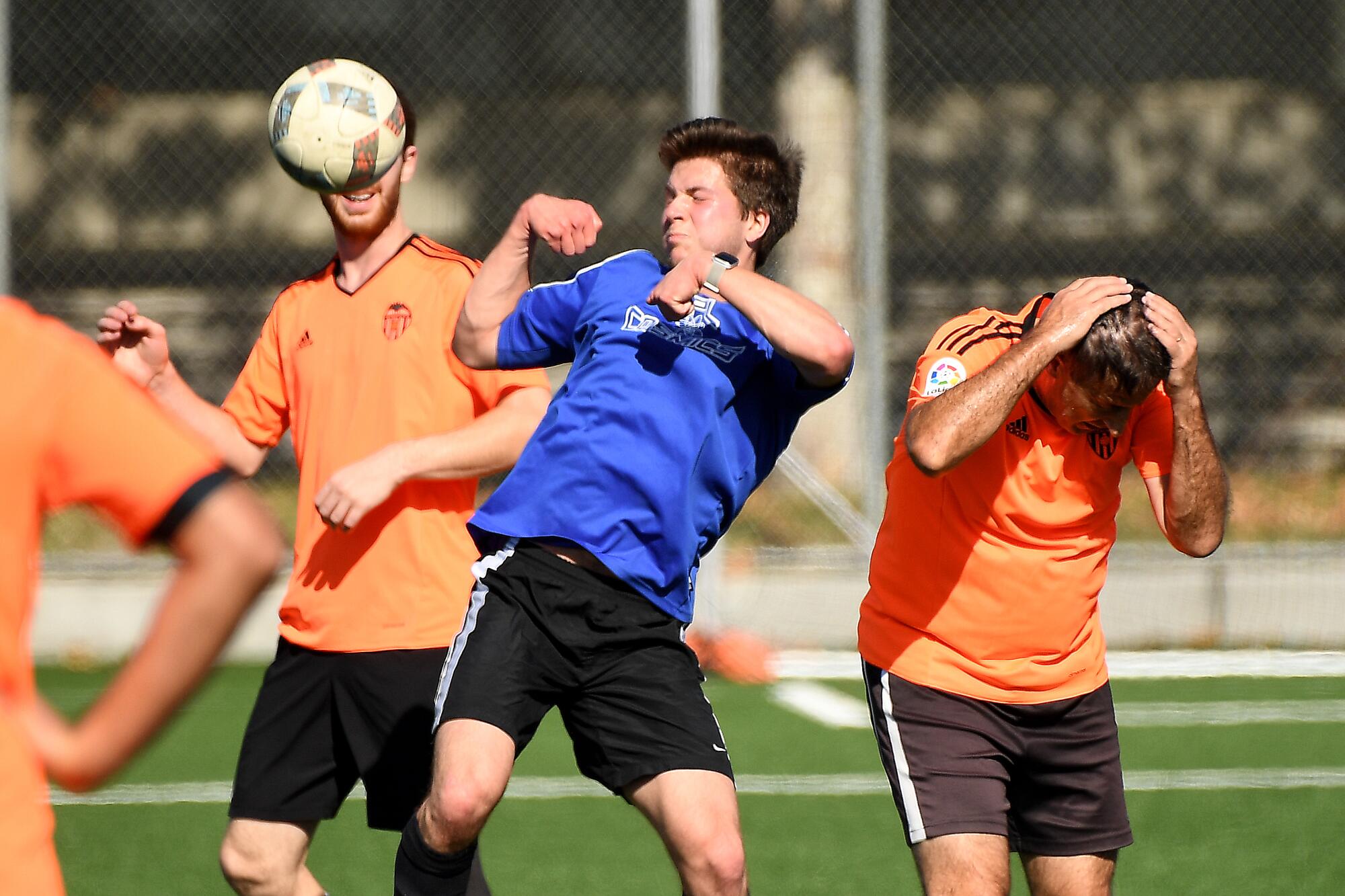 Robert Gray, center, battles for the ball during a Nerd Soccer League game at Caltech in Pasadena.