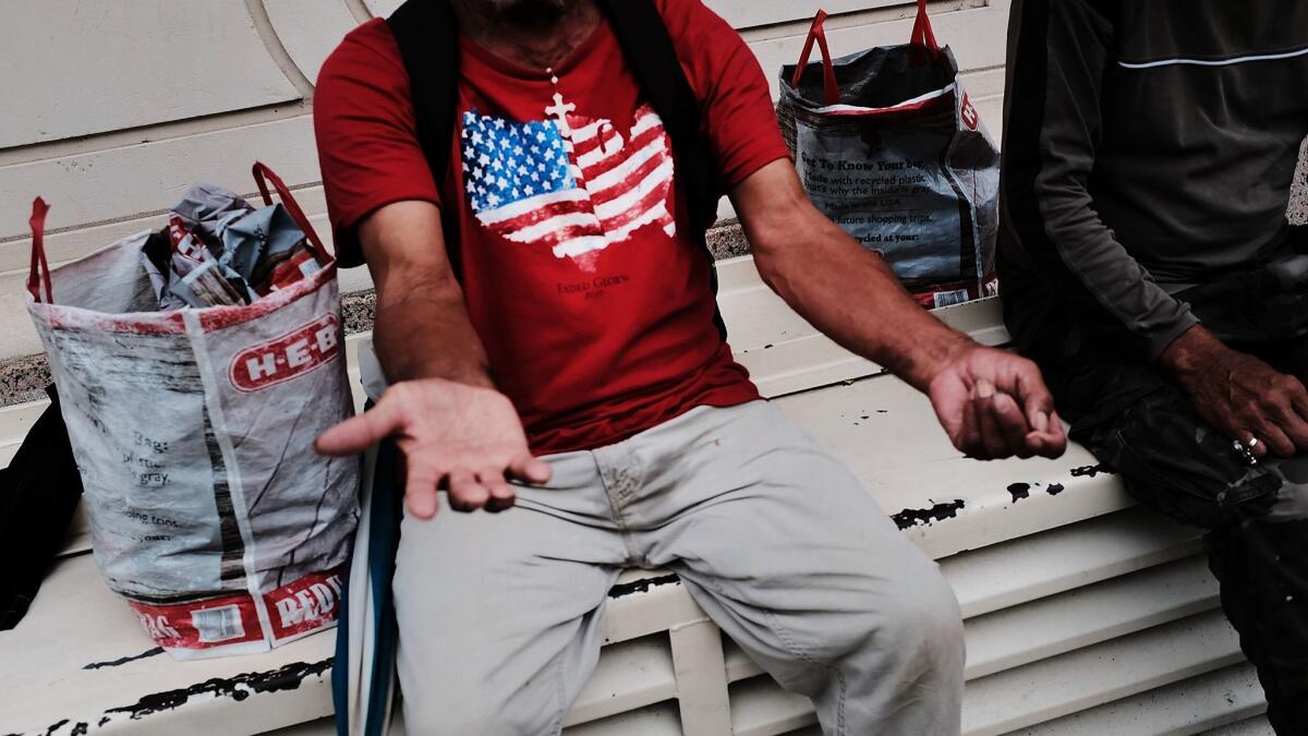 A homeless man sits on a bench in Brownsville, Texas, on June 21.