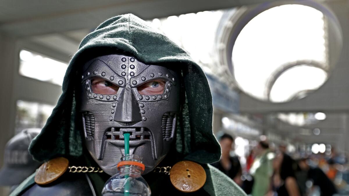 Andy Tymczyszyn of Moorpark sips Gatorade through his Dr. Doom-Fantastic 4 costume on the opening day of Comic-Con International 2017. https://lat.ms/2tgDx5r