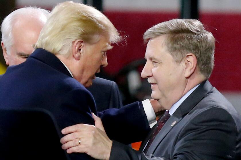 President Donald Trump, left, greets Rick Saccone after speaking at H&K Equipment, Co. on Thursday, Jan. 18, 2018 in Coraopolis, Pa. Saccone is running for the U.S. Congressional seat vacated by Tim Murphy.(AP Photo/Keith Srakocic)