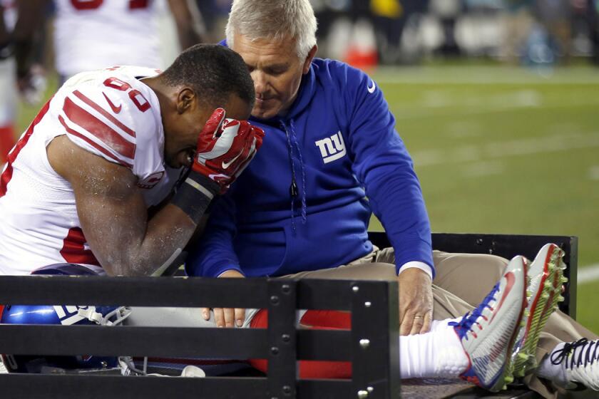 Giants wide receiver Victor Cruz is carted off the field after tearing the patellar tendon in his right knee during the second half of a game against the Eagles on Sunday night in Philadelphia.