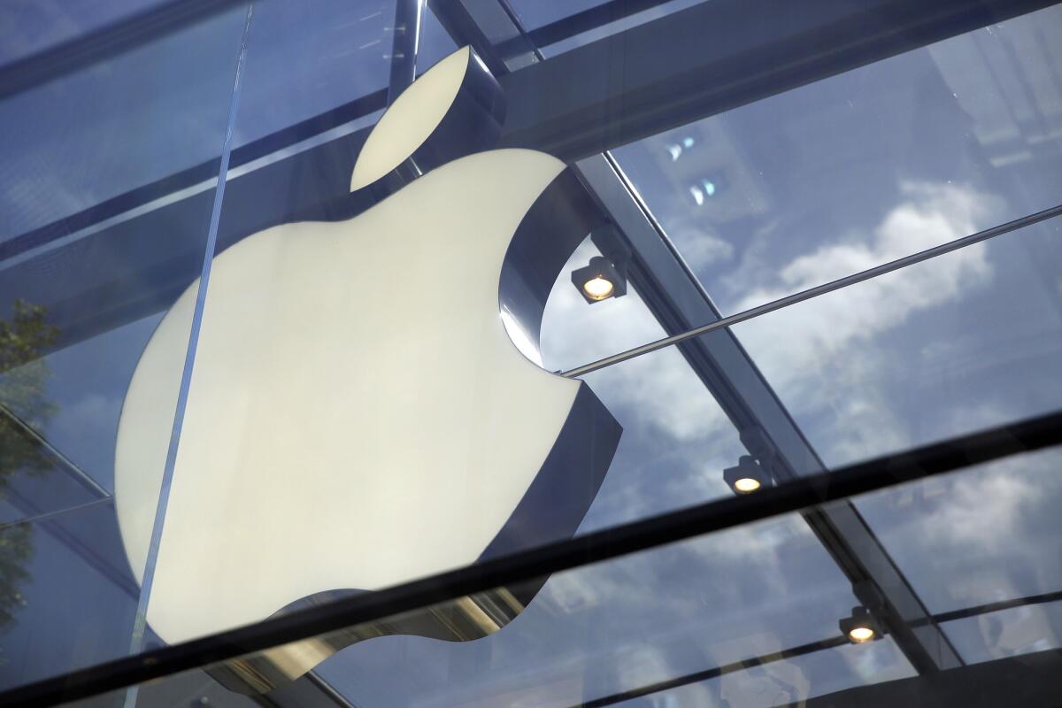 The Apple logo is seen on an Apple Store in Palo Alto, Calif.