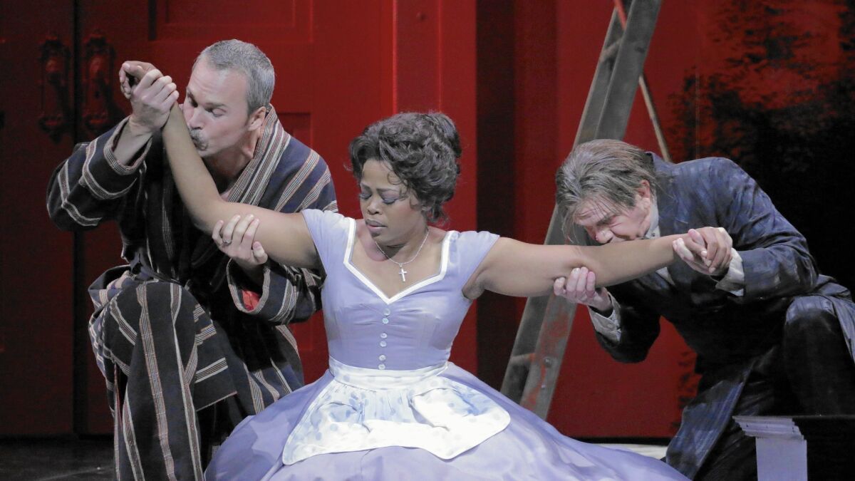 Ryan McKinny, left, as Count Almaviva, Pretty Yende as Susanna and Robert Brubaker as Don Basilio in L.A. Opera's production of Mozart's "The Marriage of Figaro" at the Dorothy Chandler Pavilion in Los Angeles.