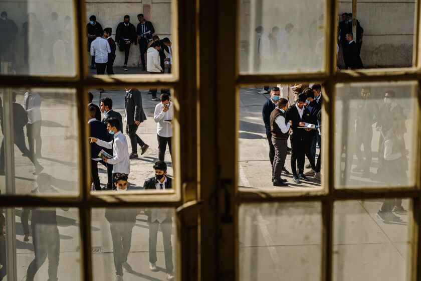BAGHDAD, IRAQ -- DECEMBER 2, 2021: Students step out for a recess in between classes at the Sharqiyah Preparatory School in the Karradeh neighborhood of Baghdad, Iraq, Thursday, Dec. 2, 2021. Born after the 2003 U.S. occupation, the children growing up in the shadow of the U.S.'s war on Iraq contend with an unstable country as they approach graduation. (MARCUS YAM / LOS ANGELES TIMES)