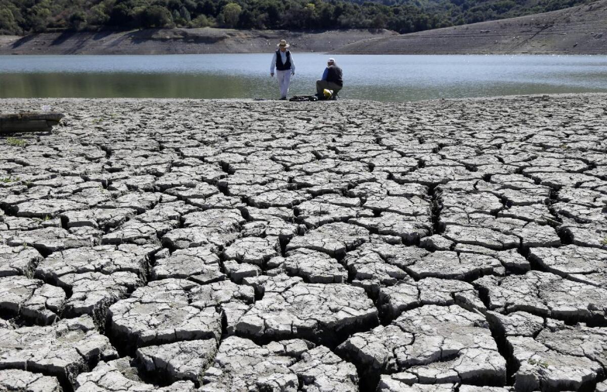 The Obama administration is more certain than ever that global warming is changing Americans' daily lives and will worsen -- conclusions that scientists detailed detail in a federal report released Tuesday. Above, the dry bed of the Stevens Creek Reservoir in Cupertino.