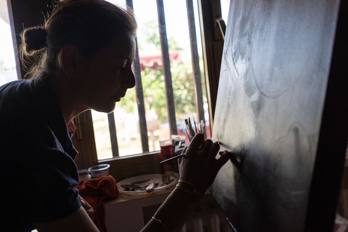 Carla Lucarelli uses art to channel her grief after the death of her son Giorgio, and a recent series of paintings focuses on the Ilva plant.