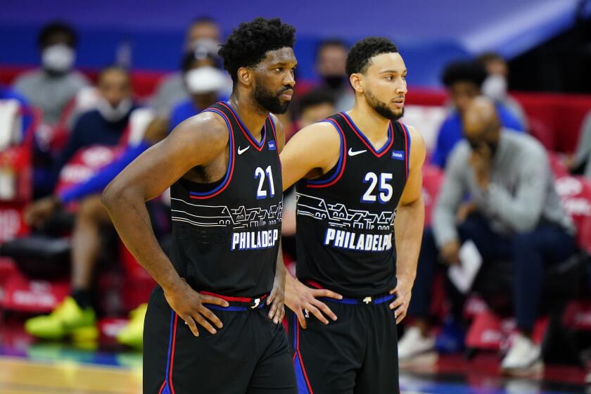 Philadelphia 76ers' Joel Embiid and Ben Simmons talk during an NBA basketball game against the Brooklyn Nets, Saturday, Feb. 6, 2021, in Philadelphia. (AP Photo/Matt Slocum)