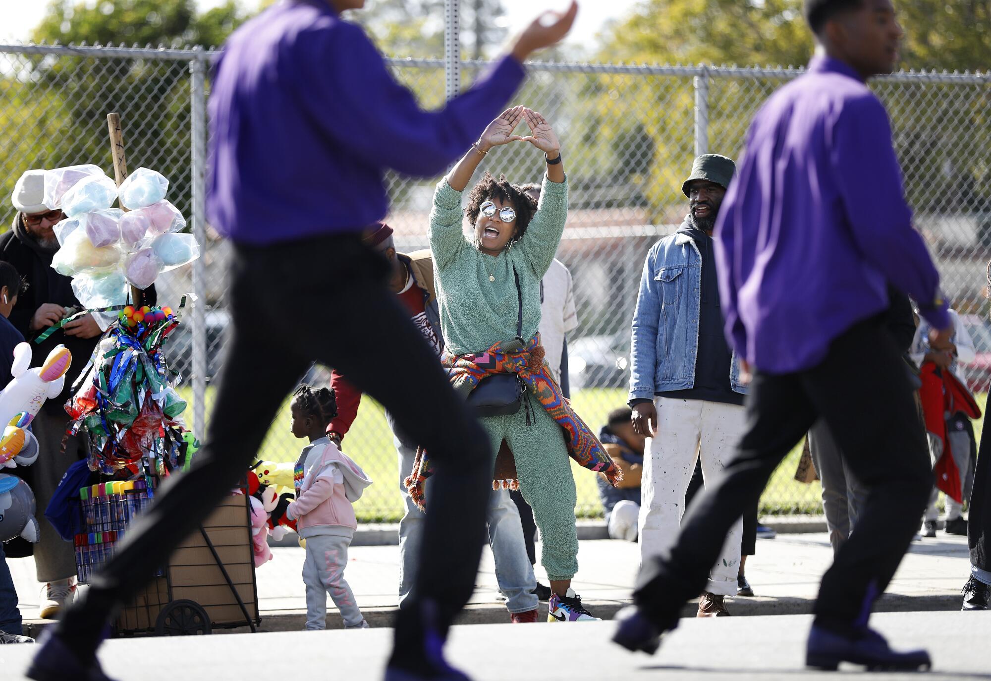 Jovian Zayne, center, dances along with participants in the 38th Annual Kingdom Day Parade in Leimert Park.