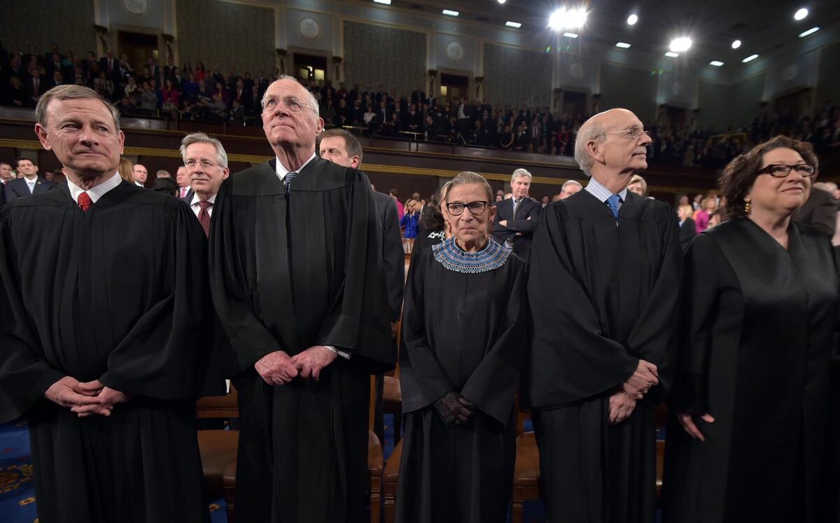 From left, Chief Justice John G. Roberts and Supreme Court justices Anthony M. Kennedy, Ruth Bader Ginsburg, Stephen G. Breyer and Sonia Sotomayor stand before President Barack Obama's State Of The Union address on Jan. 20 in Washington.
