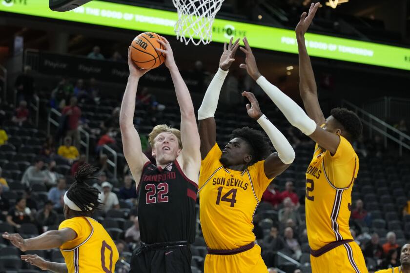 Stanford's James Keefe (22) shoots against Arizona State's Enoch Boakye (14) and Alonzo Gaffney (32) during the second half of an NCAA college basketball game in the first round of the Pac-12 tournament Wednesday, March 9, 2022, in Las Vegas. (AP Photo/John Locher)