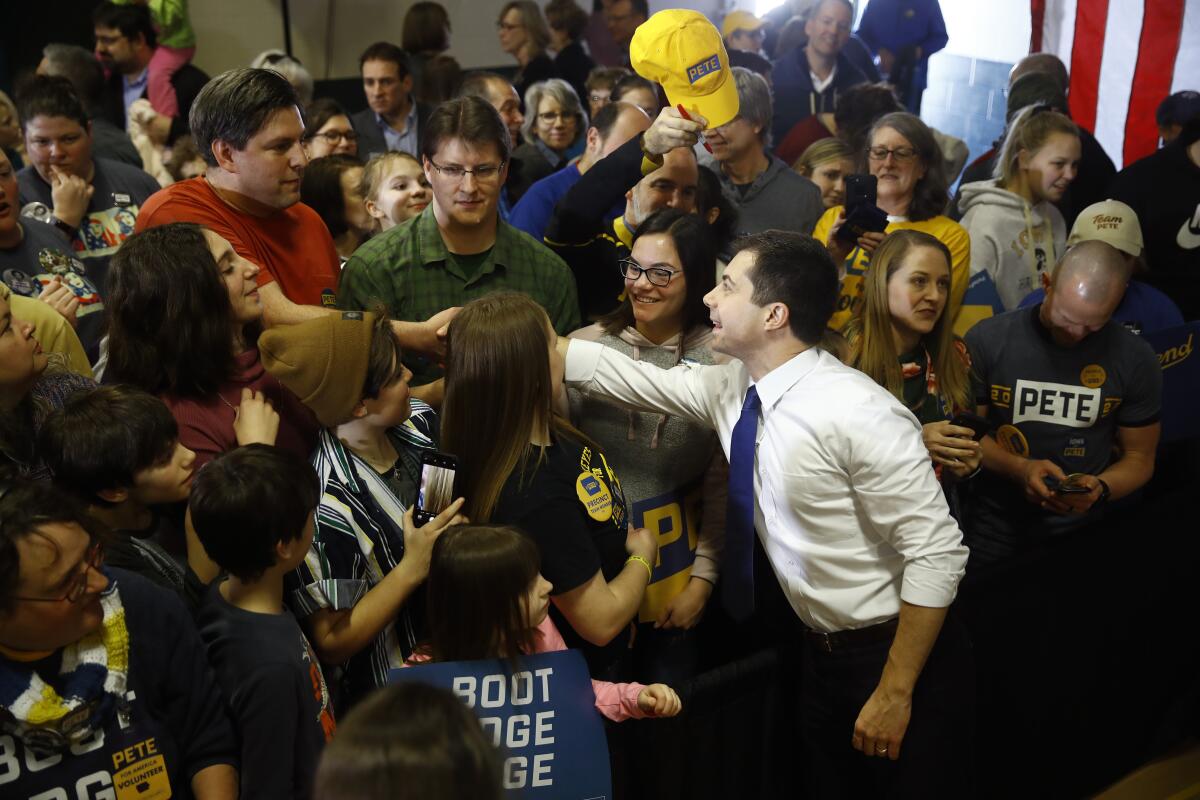 Former South Bend, Ind., Mayor Pete Buttigieg greets supporters at a campaign event Sunday at Northwest Junior High in Coralville, Iowa.