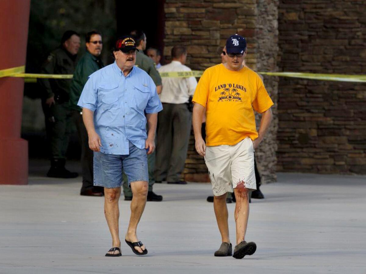 Charles Cummings, 68, left, and his son Alex, 34, witnessed the shooting inside the Cobb Grove 16 theater in Wesley Chapel, Fla., on Monday.