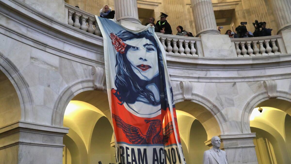 Immigration activists hang a banner in the Capitol building in Washington recently.