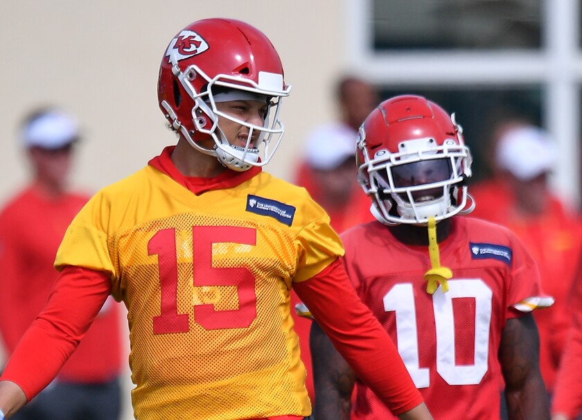 Kansas City Chiefs quarterback Patrick Mahomes, left, and wide receiver Tyreek Hill discuss a play.