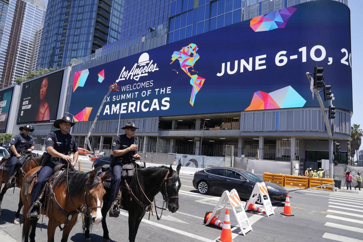 Police officers patrol in preparation for the Summit of the Americas at the L.A. Convention Center.