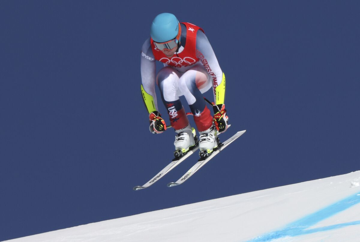 Ryan Cochran-Siegle of the United States makes a jump during the men's super-G at the 2022 Winter Olympics, Tuesday, Feb. 8, 2022, in the Yanqing district of Beijing. (AP Photo/Alessandro Trovati)