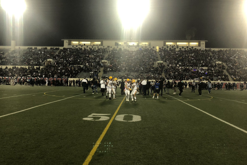 Players for Roosevelt and Garfield meet at midfield before the start of Friday's East L.A. Classic.