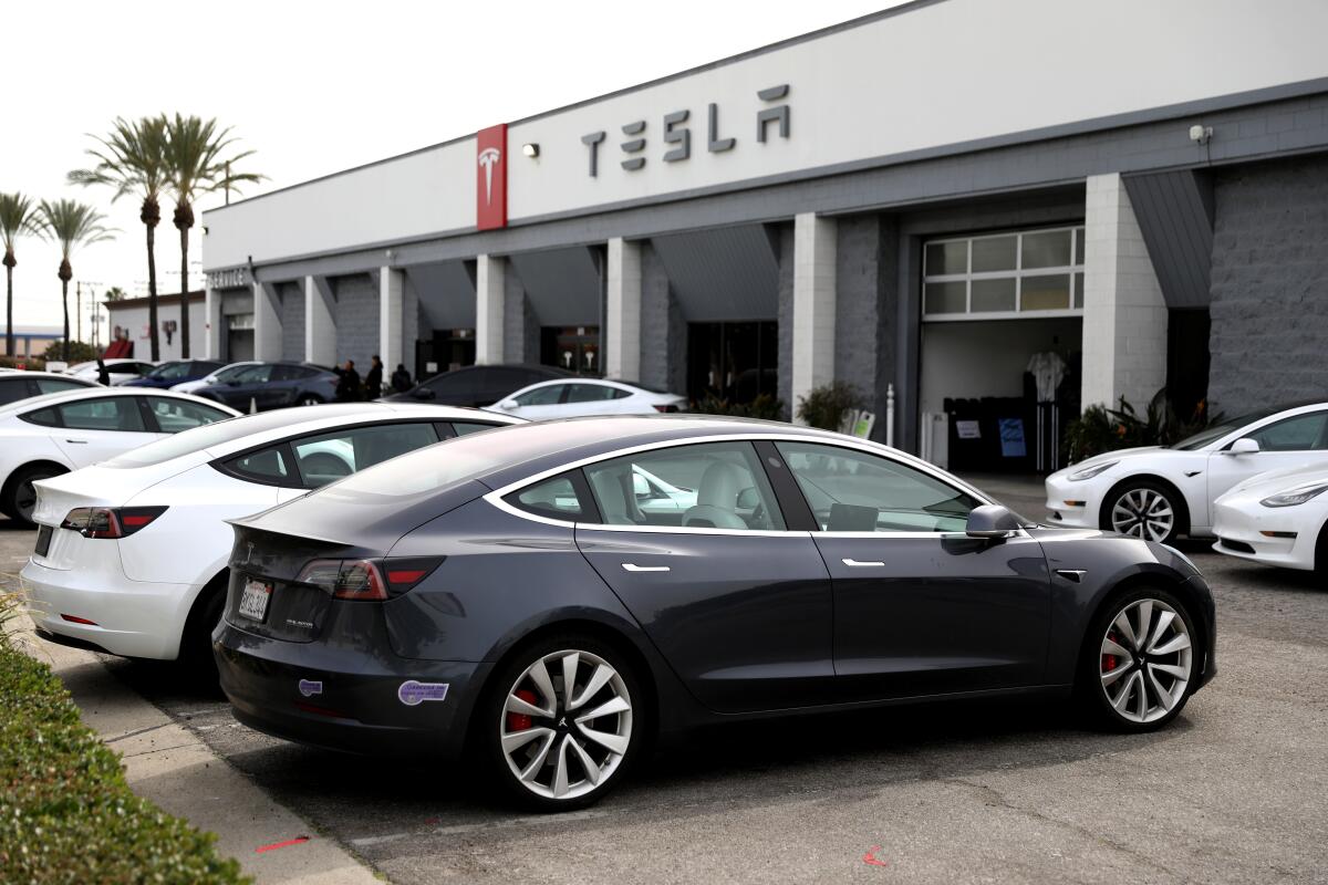 Tesla electric vehicles are parked at a dealership in Burbank on Feb. 16. 