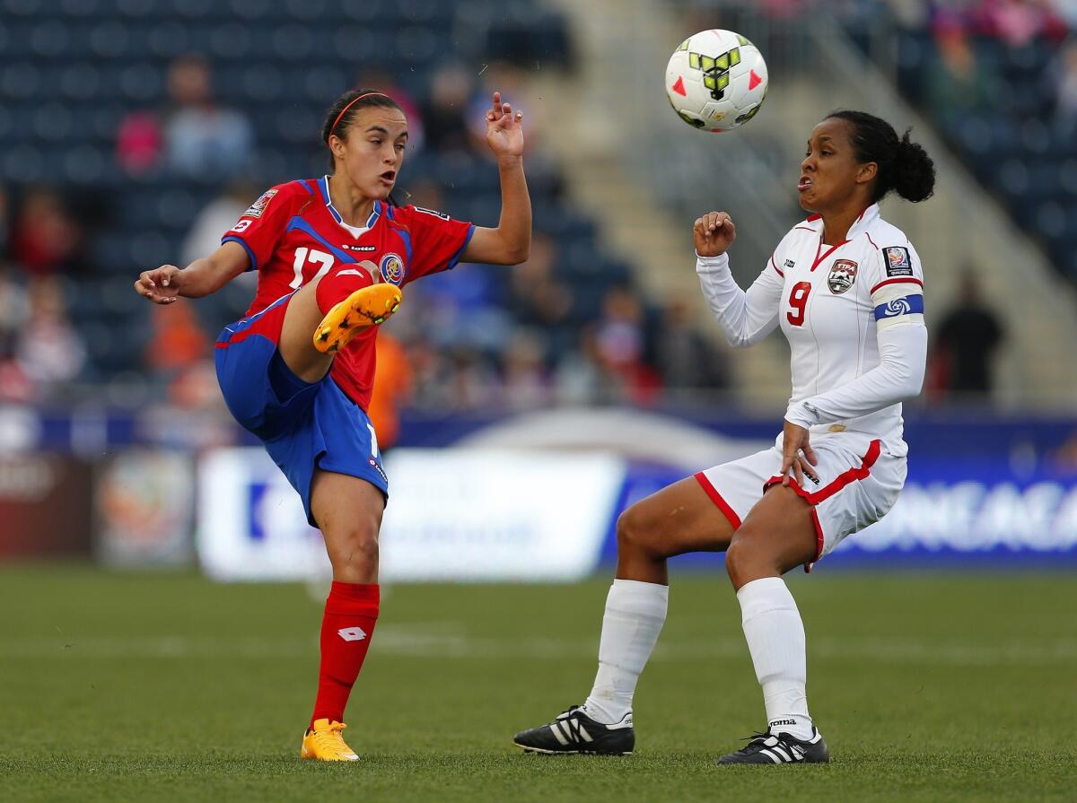 Costa Rica forward Daphnne Herrera, left, is defended by Trinidad and Tobago midfielder Maylee Attin Johnson Friday in Chester, Pa.