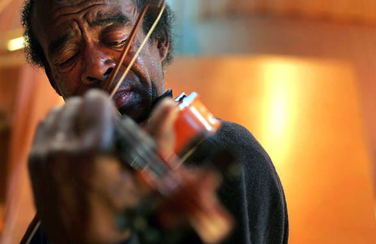 Music is the passion of Nathaniel Ayers, shown here playing the violin at Disney Hall in Los Angeles.