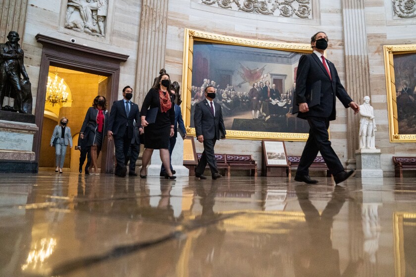 House impeachment managers walk to the Senate chamber on the first day of Donald Trump's second impeachment trial.