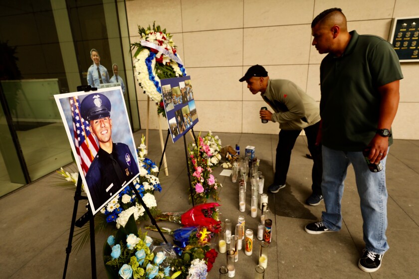 Chris Martin, center, and Ricardo Camacho at a memorial for Juan Jose Diaz