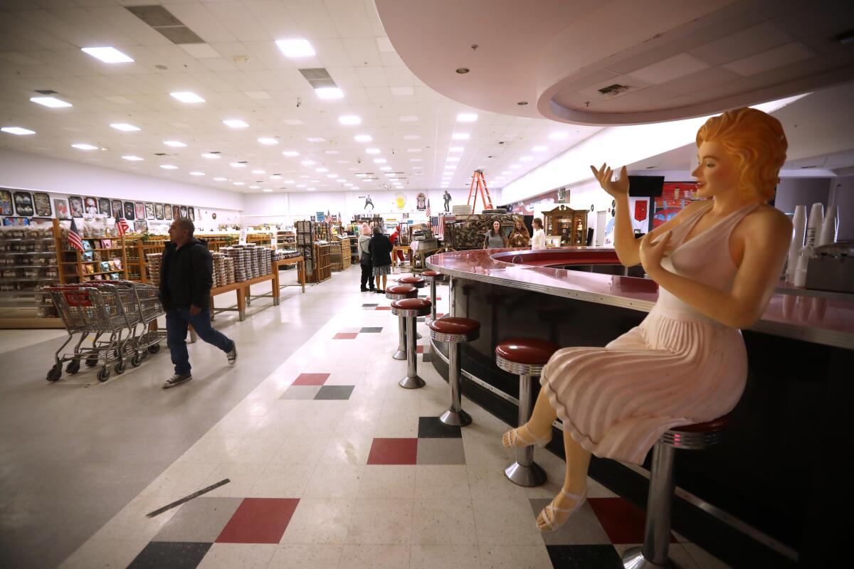 A figure of Marilyn Monroe sits on a stool as shoppers visit Blackwell's Corner in January 2024.