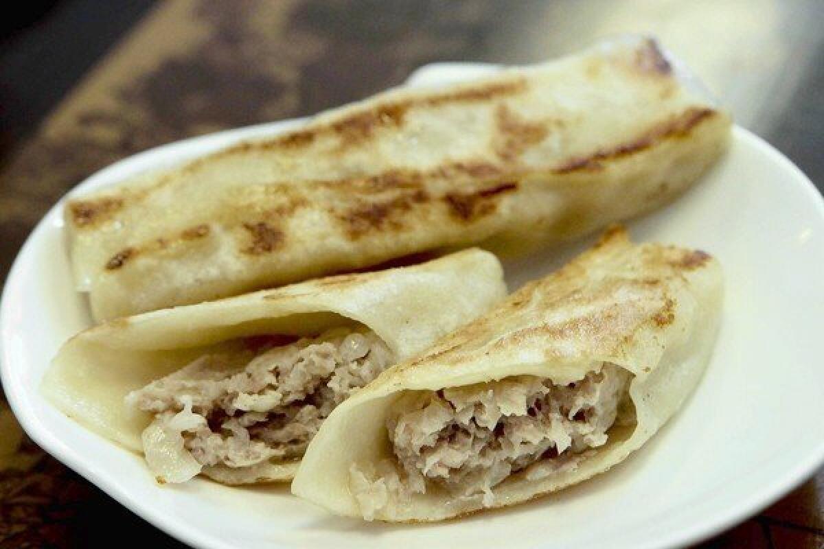 Hui tou are the signature dish, a sort of Chinese blintz filled with pork (and pork juices — be sure to put a napkin on your lap).