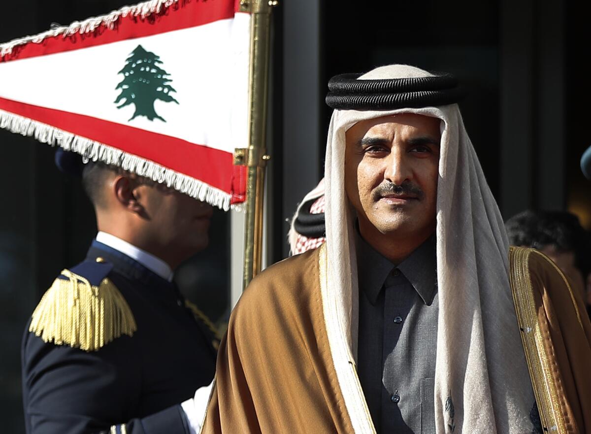 FILE - Qatar's Emir Sheikh Tamim bin Hamad Al Thani reviews the honor guard as he arrives at the Rafik Hariri international airport in Beirut, Lebanon, Sunday, Jan. 20, 2019. (AP Photo/Hussein Malla, File)