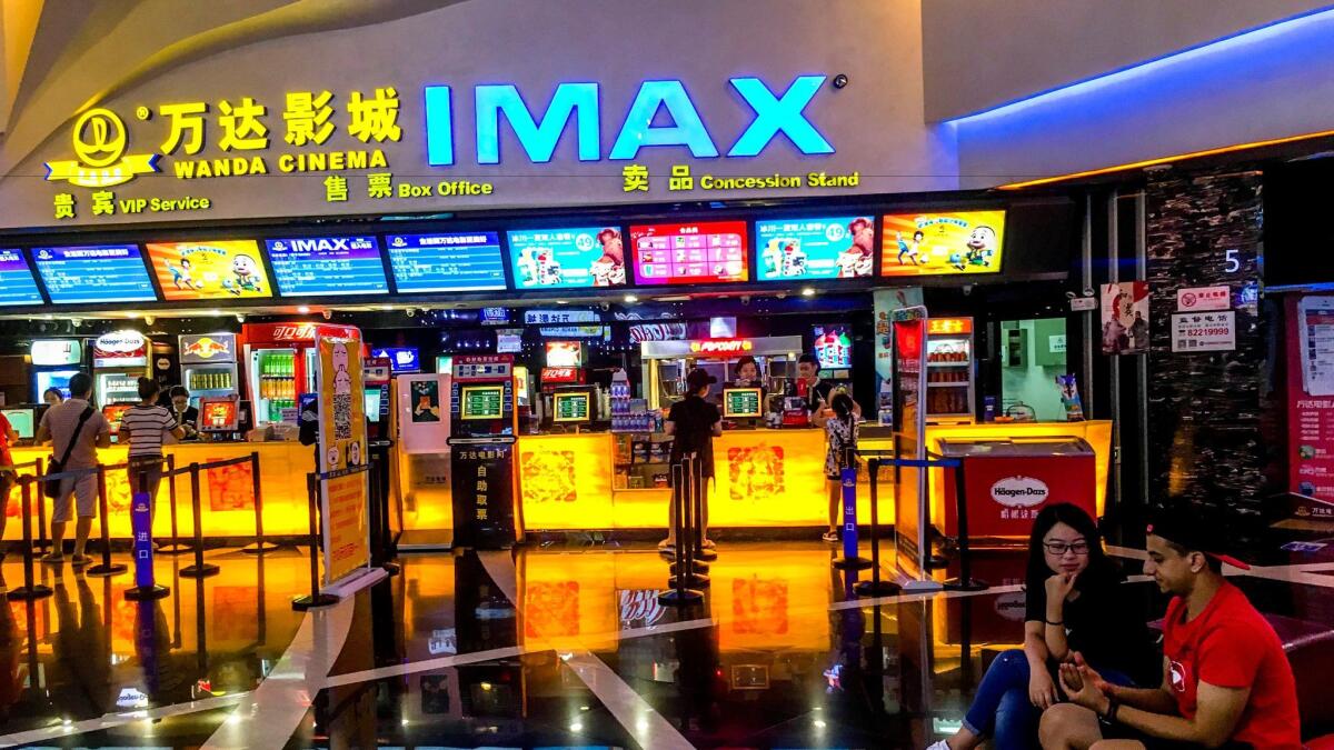 Customers buy movie tickets in a Wanda IMAX cinema in China.