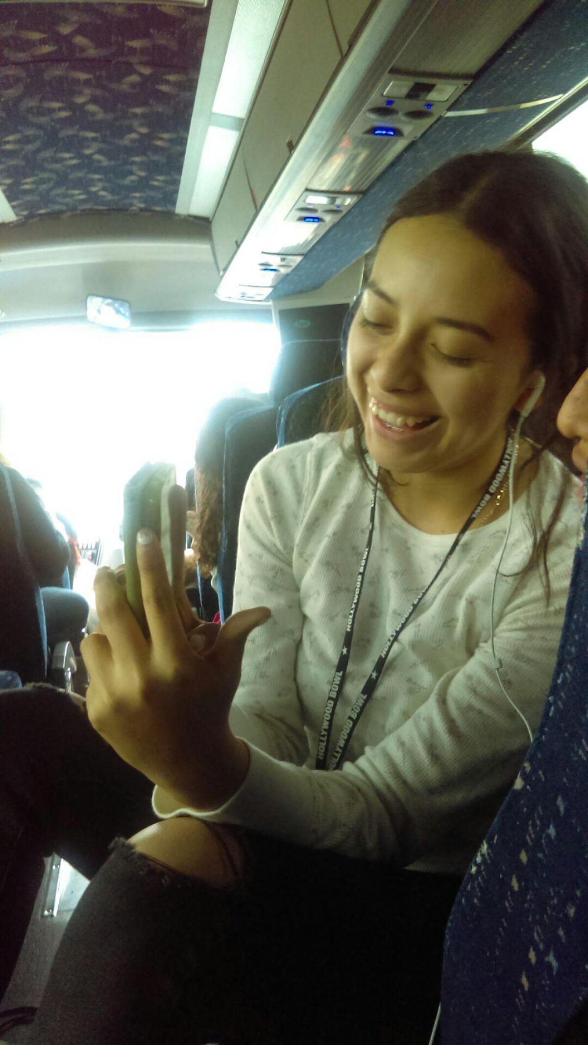 Lizeth Martinez keeps busy with Snapchat filters on our four-hour bus ride to Visalia.