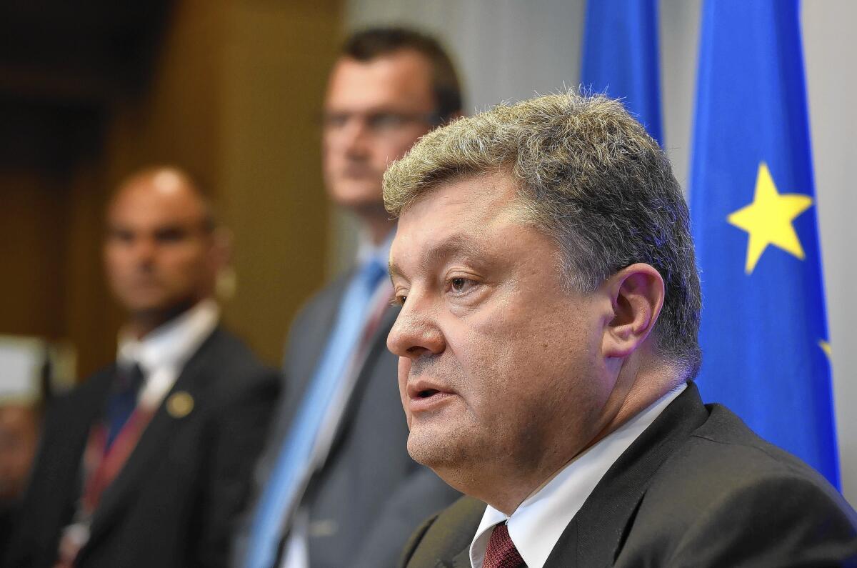 Ukrainian President Petro Poroshenko speaks to reporters at the European Union headquarters in Brussels on Aug. 30.
