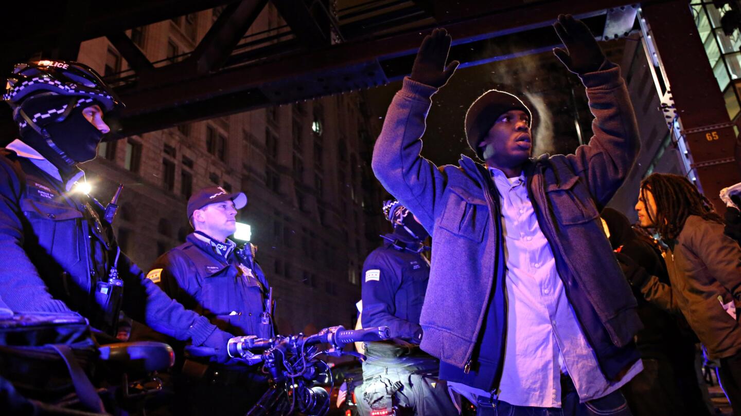 Protesters face off with Chicago police while marching in the Loop in reaction to the grand jury decision in Ferguson, Missouri on Monday, Nov. 24, 2014. Ferguson police officer Darren Wilson was not indicted earlier Monday in the shooting death of Michael Brown.