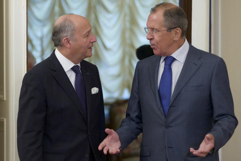 Russian Foreign Minister Sergei Lavrov, right, greets his French counterpart, Laurent Fabius, before a meeting in Moscow.