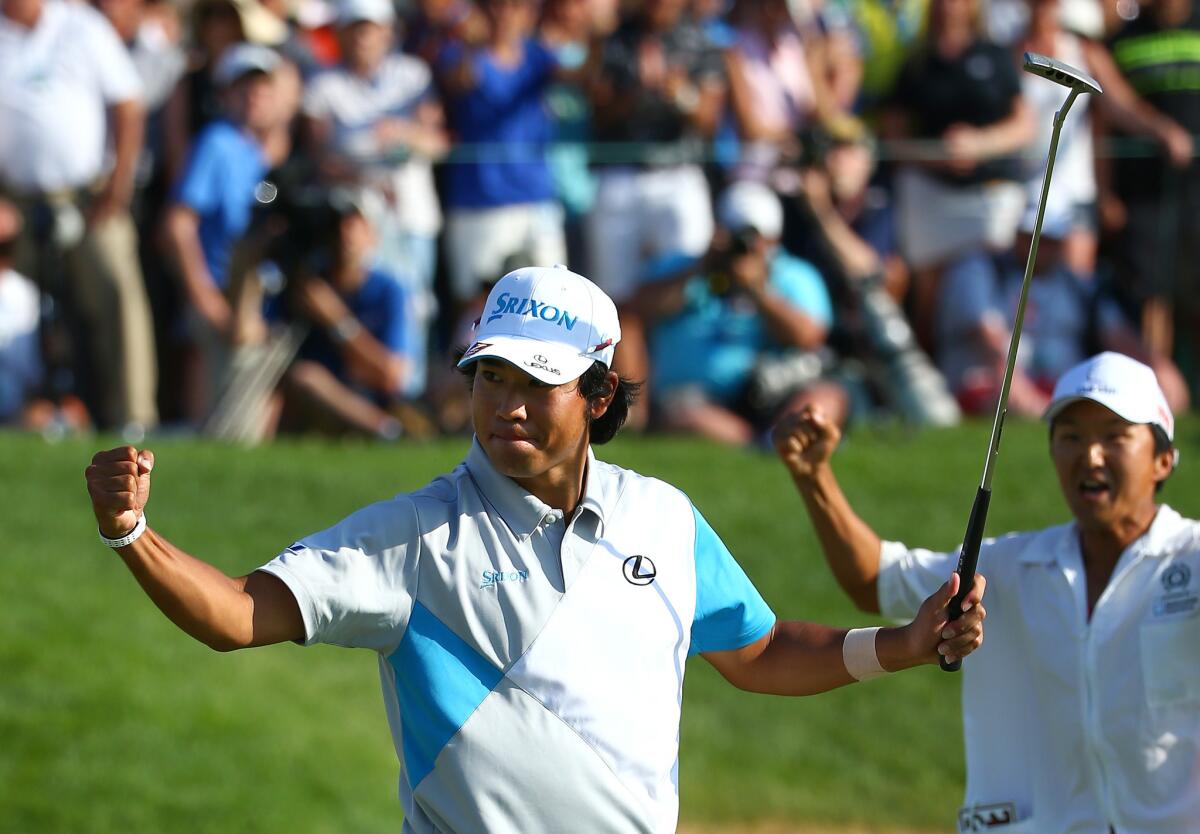 Hideki Matsuyama reacts along with his caddie after sinking the winning putt on the first playoff hole at the Memorial on Sunday.