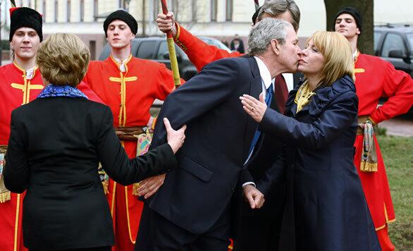 President Bush kisses Ukrainian President Viktor Yushchenko's wife, Kateryna, while Laura Bush holds his arm during a parting ceremony in Kiev on April 1. Bush arrived in the Ukraine on March 31 to begin a tour that took him to Romania for a summit of the NATO military alliance April 2 to 4 and then to Russia for talks with President Vladimir Putin.