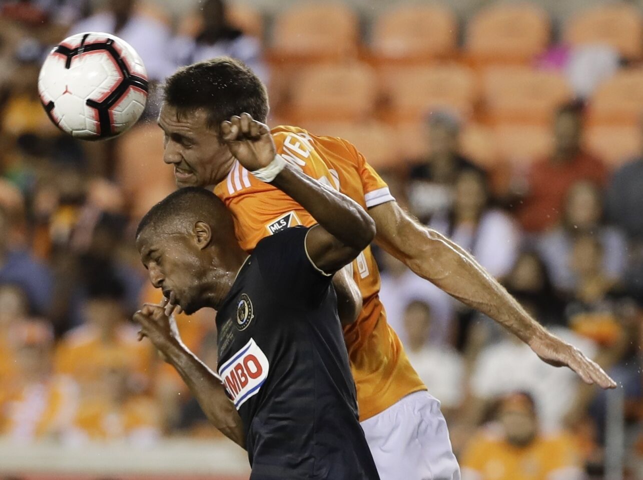 Philadelphia Union's Fafa Picault and Houston Dynamo's Andrew Wenger battle for a shot during the first half of the U.S. Open Cup championship soccer match Wednesday, Sept. 26, 2018, in Houston. (AP Photo/David J. Phillip)