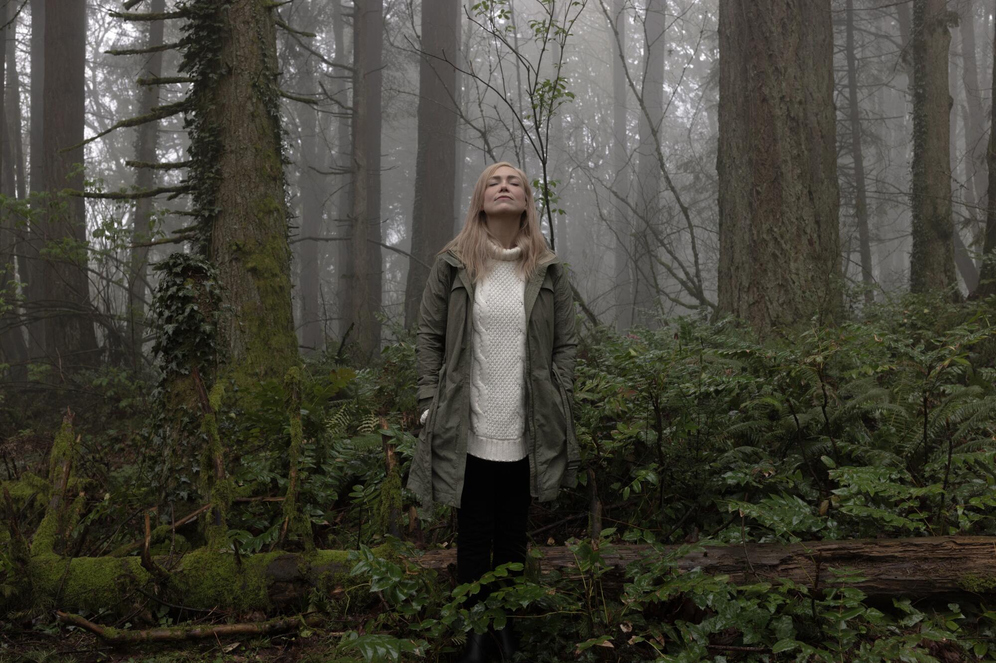 A woman standing in a nature park in the Pacific Northwest